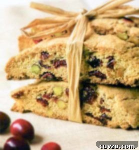 Festive Cranberry Pistachio Biscotti 4 Several festive cranberry pistachio biscotti cookies, neatly tied together with raffia, ready for gifting or serving.