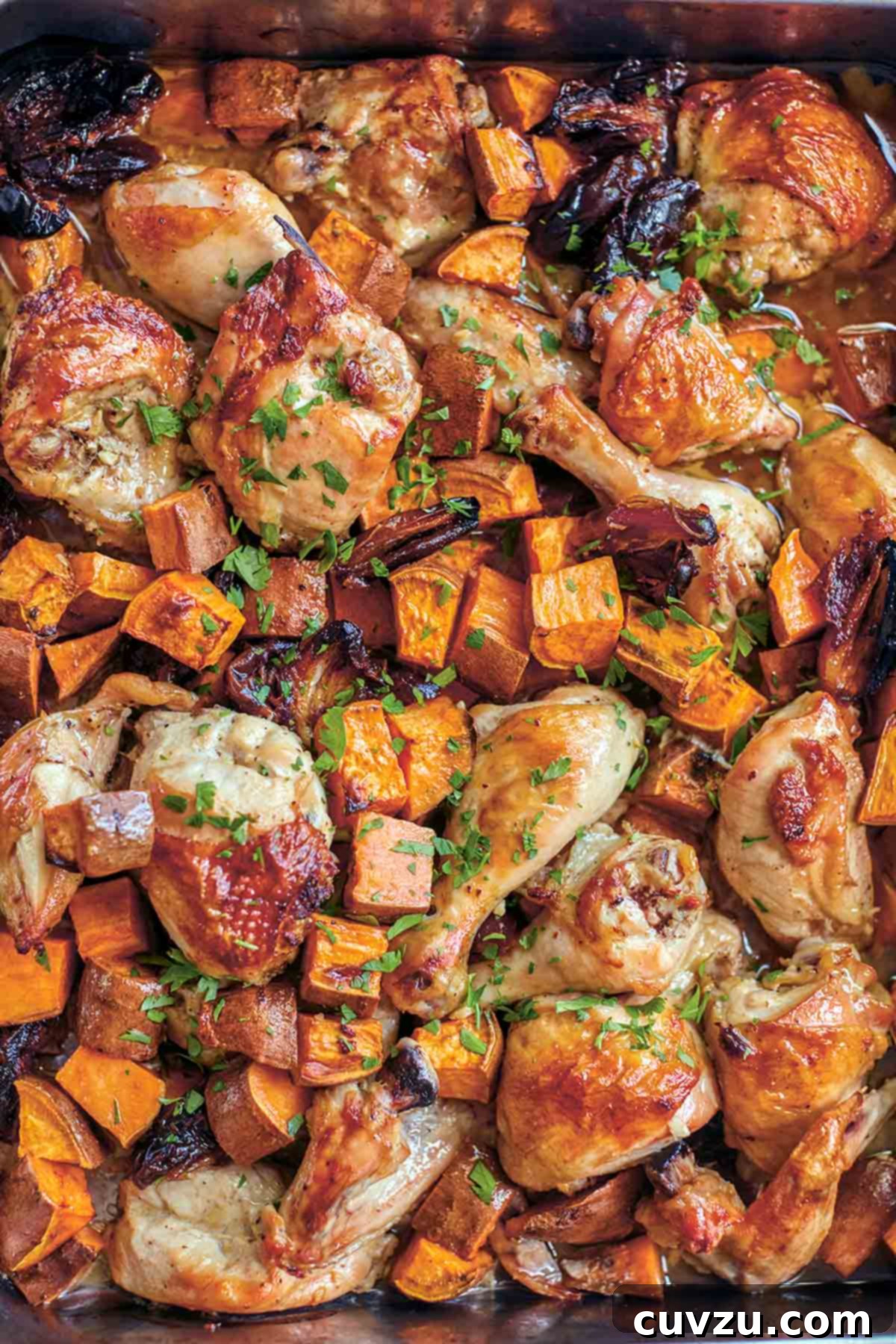Rosh Hashanah Feasts: 11 Must-Try Recipes 8 A sheet pan filled with roast chicken pieces, sweet potato chunks, dates, and a parsley garnish.