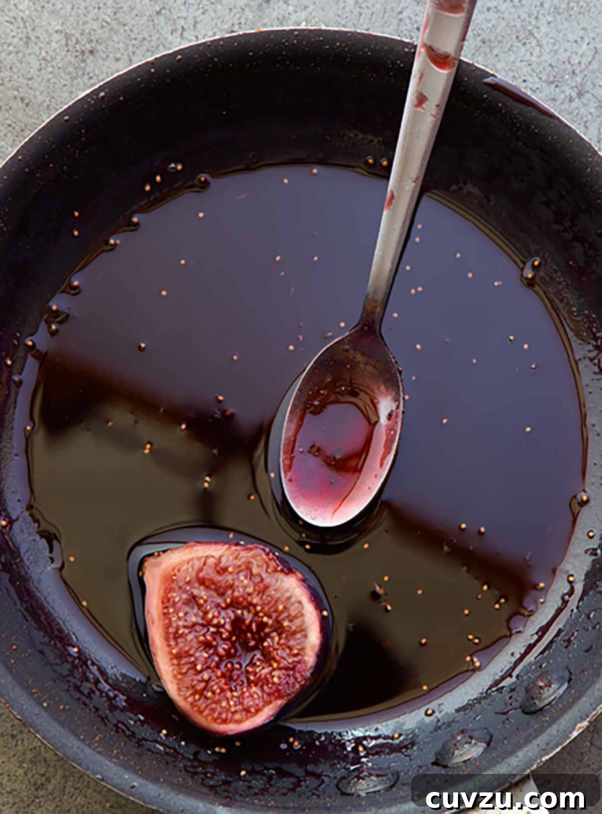 Rosh Hashanah Feasts: 11 Must-Try Recipes 10 A black skillet with figs in Port wine and a spoon on the side.