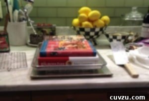Weighting the stack of sandwiched rainbow cookie cake layers.