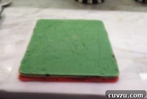 Photo of all three rainbow cookie cake layers stacked on top of each other.