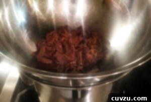 Melting the chocolate for the Rainbow Cookies in a bowl set over simmering water.