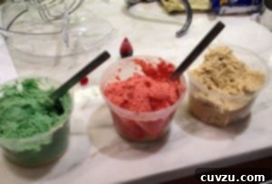3 plastic containers of Rainbow Cookies batter colored green, red and white.