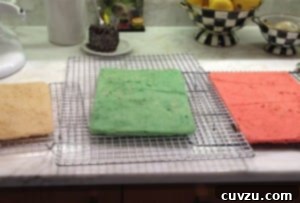 Rainbow Cookie cakes baked and cooling on cooling racks.