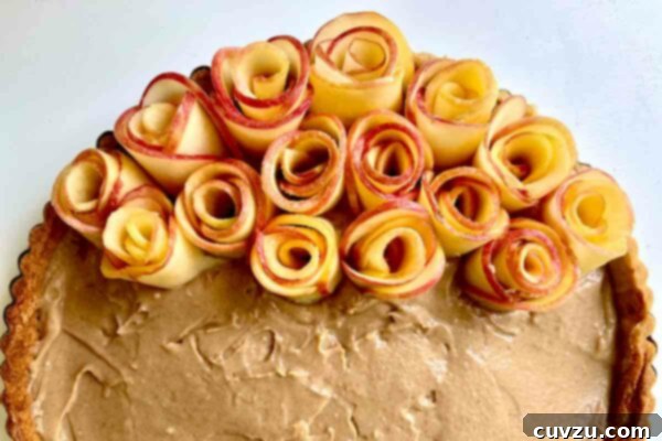 Apple Blossom Tart 7 A partially assembled rose tart, showing apple roses being placed.