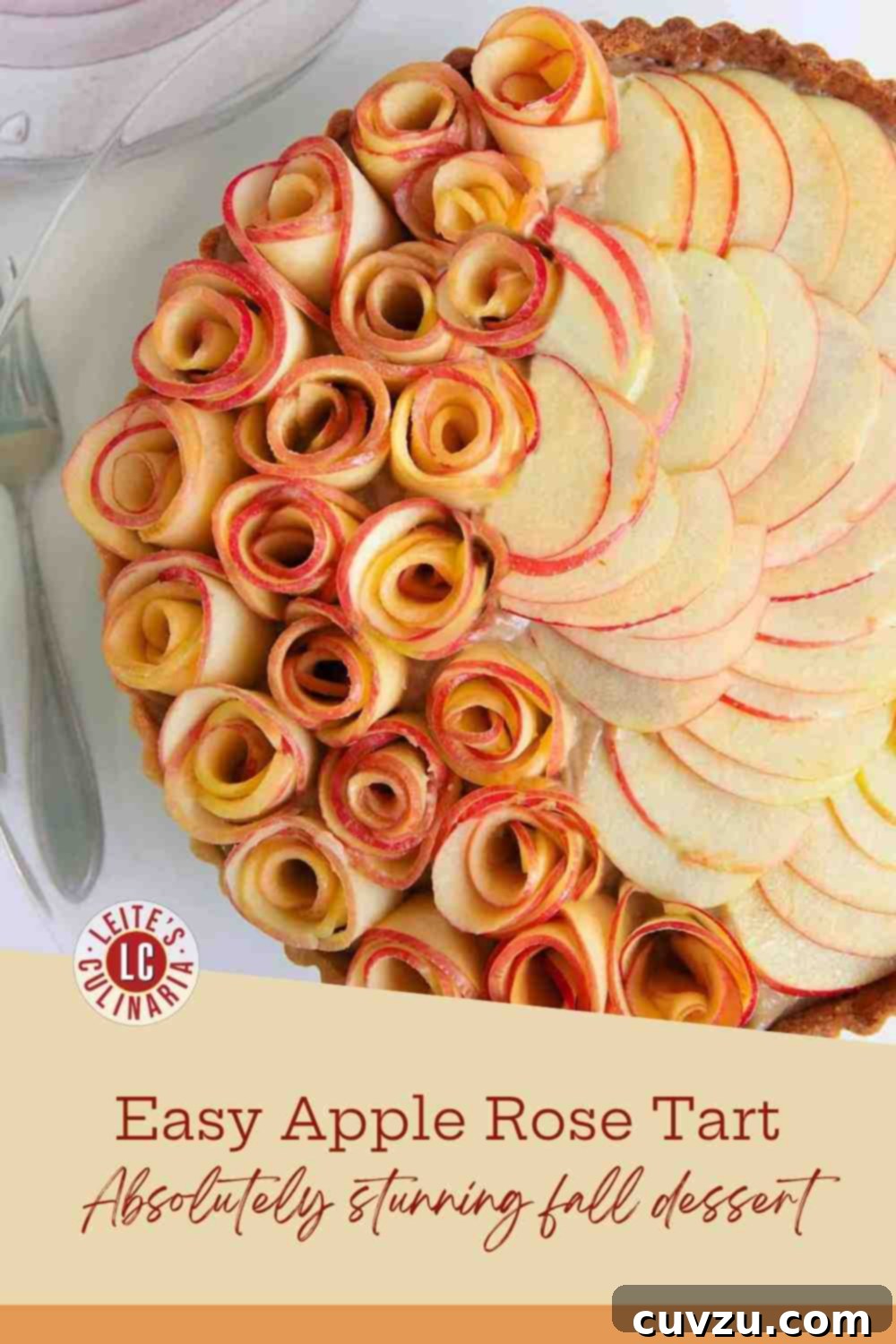Apple Blossom Tart 3 Close-up of an elegant dessert tart topped with raw apple slices curled into rosettes over a creamy apple-butter custard and shortcrust.