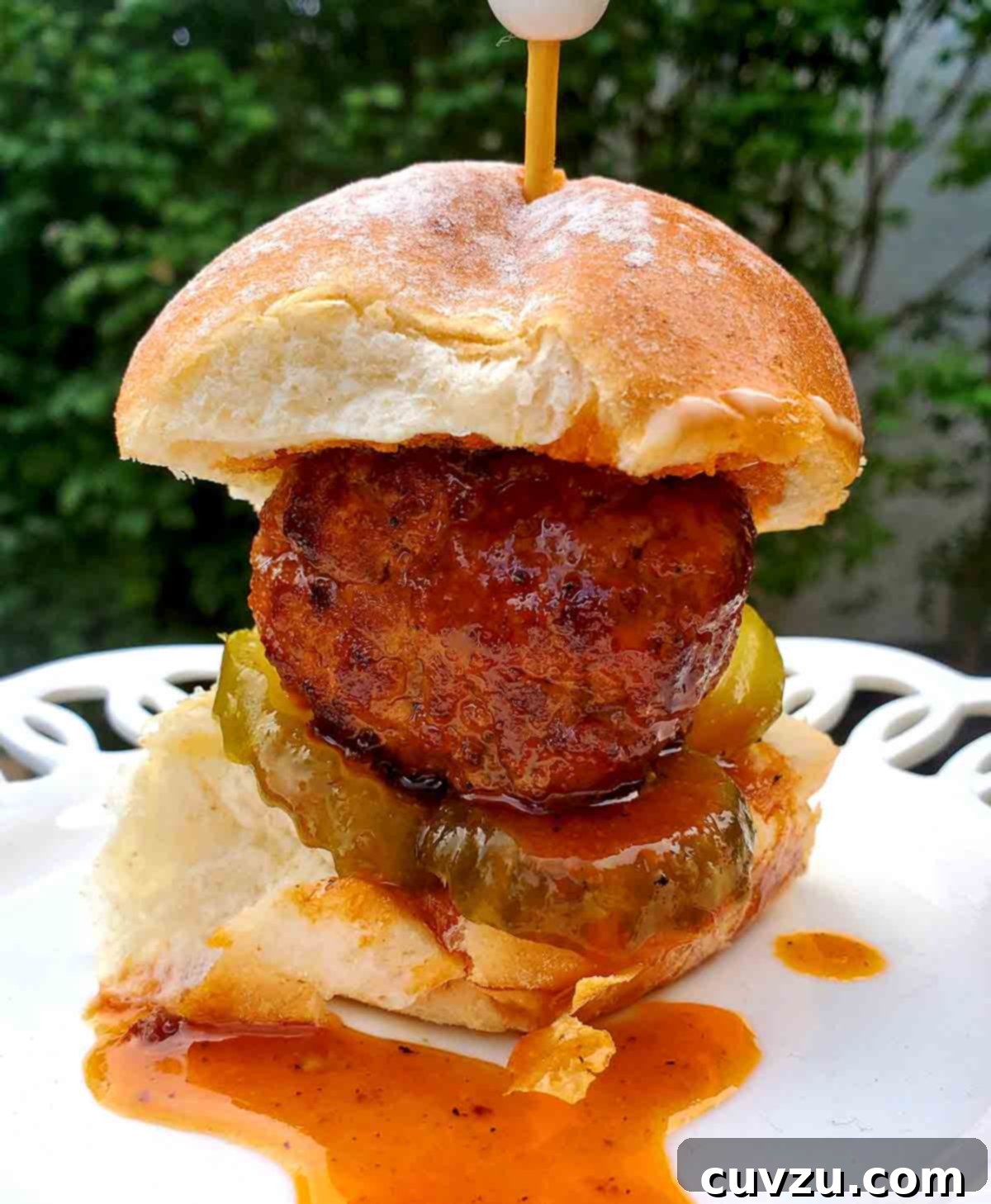 Nashville Heatwave Sliders 6 Nashville hot chicken slider on a white plate, with a toothpick and barbecue sauce.