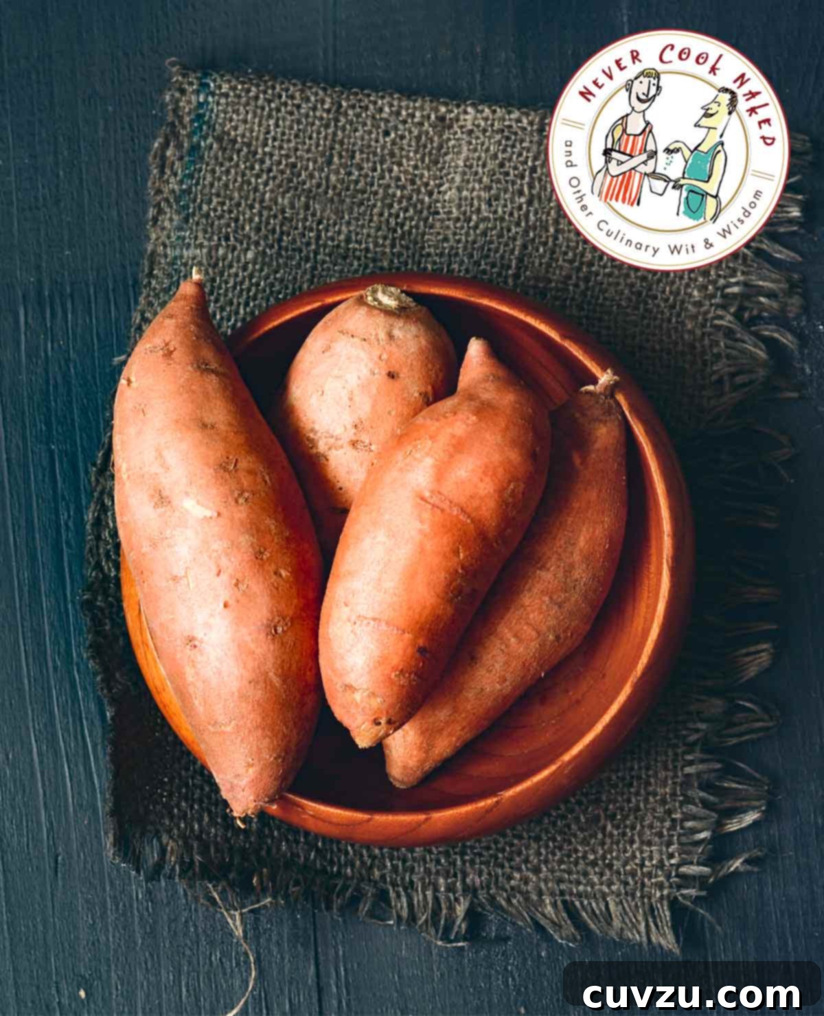 Peel Sweet Potatoes Safely: Hand Protection Tips 2 Four vibrant sweet potatoes resting in a rustic wooden bowl, placed on a piece of natural burlap, illustrating the subject of hand protection during peeling.