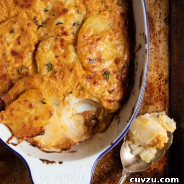 A casserole dish with cheesy pumpkin potato gratin