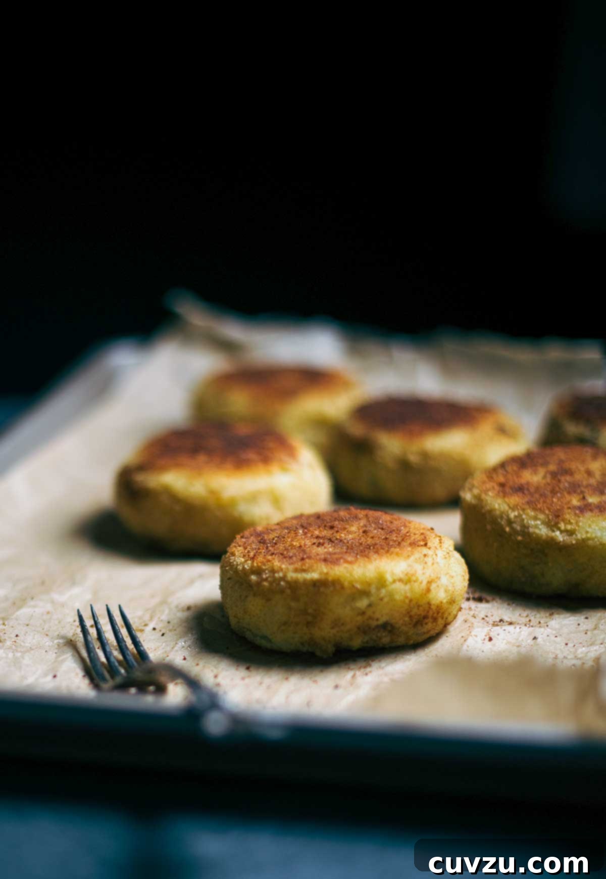Beyond the Sandwich: 9 Epic Thanksgiving Leftover Ideas 11 A sheet pan with six ground lamb and potato patties on parchment paper.