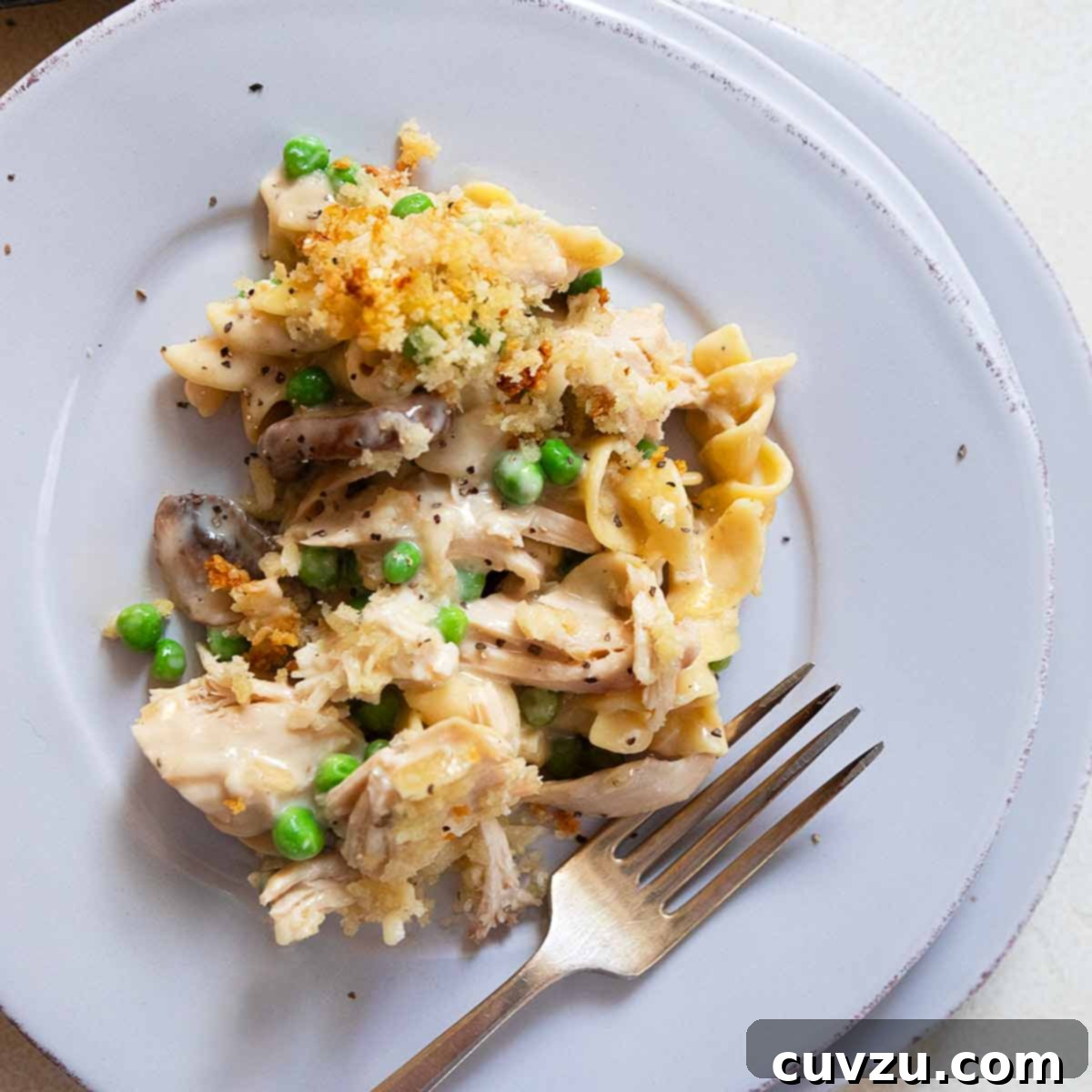 Beyond the Sandwich: 9 Epic Thanksgiving Leftover Ideas 3 A portion of turkey tetrazzini on a plate with a fork next to it.