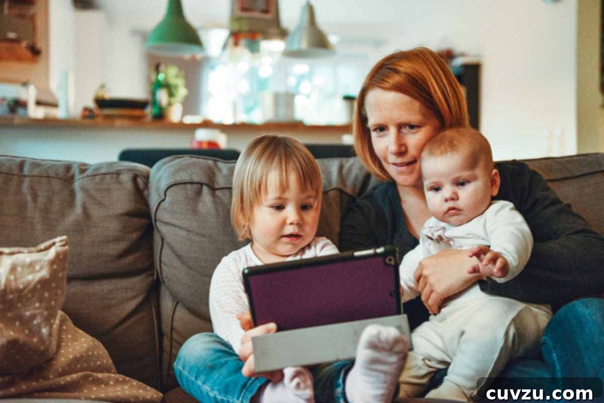 Sous Vide Explained 4 A woman holding a baby and sitting next to a child while watching something on a tablet.