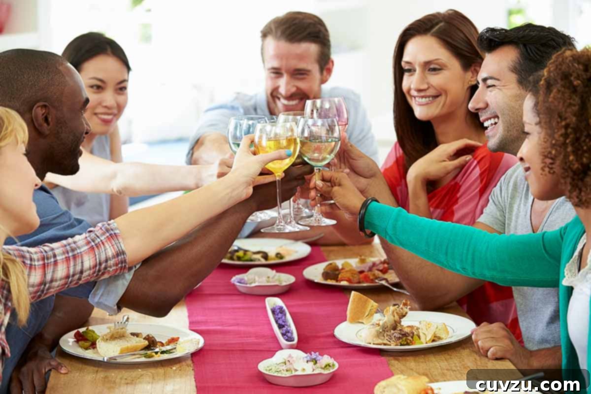Sous Vide Explained 8 A group of friends sitting at a table toasting wine glasses.