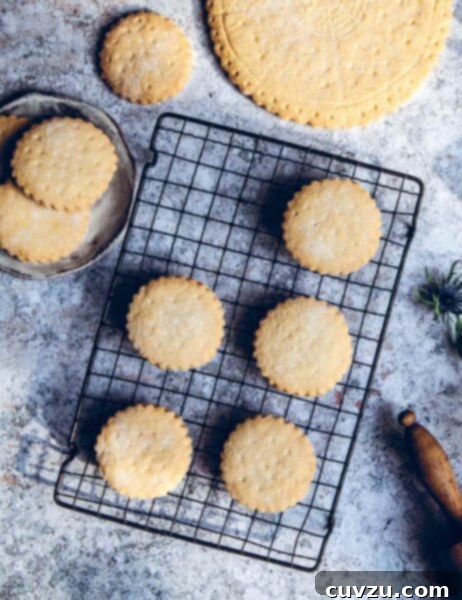 Easy shortbread cookies cooling on a wire rack, beside a rolling pin and a large shortbread petticoat.