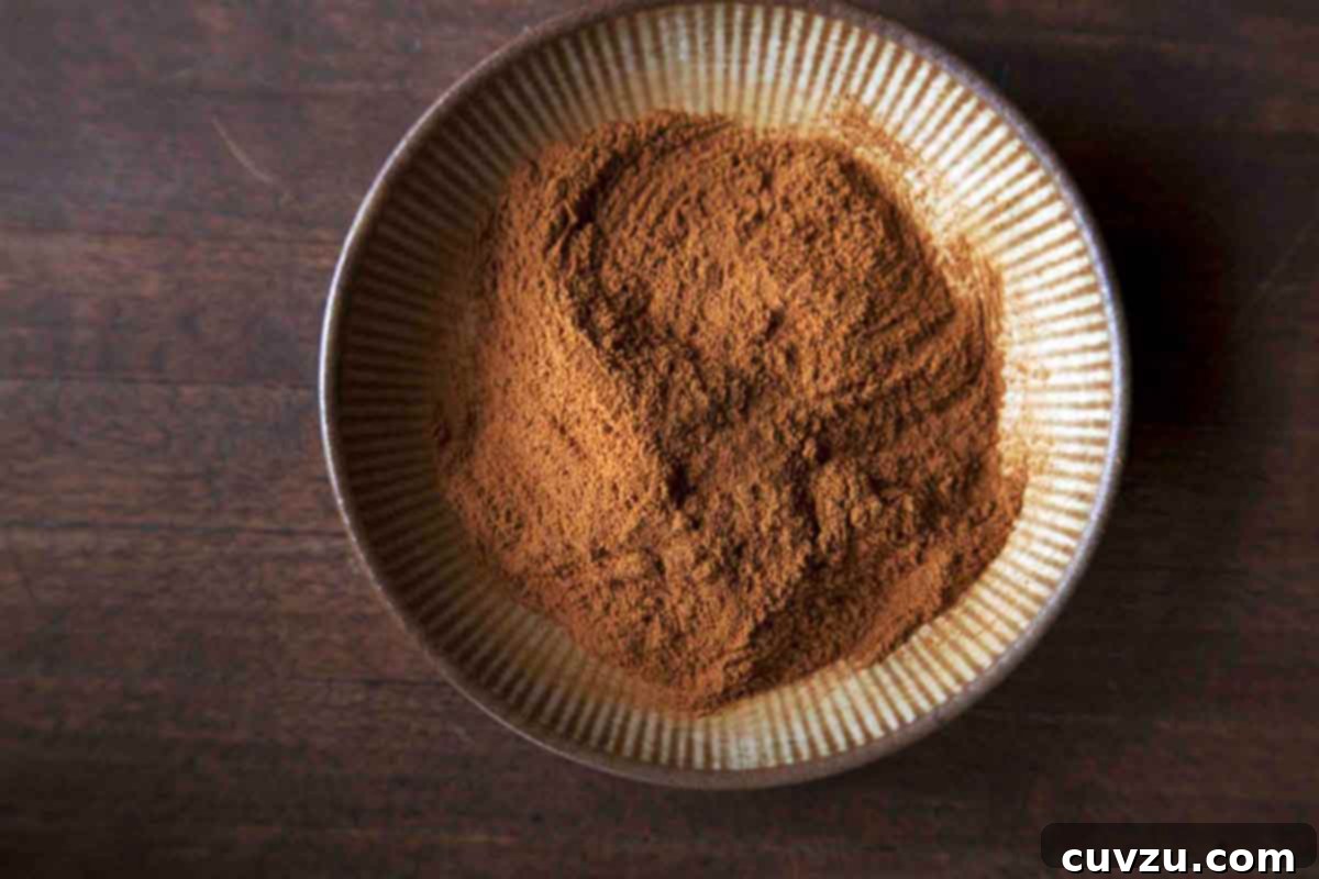 A close-up shot of rich, reddish-brown Indonesian cinnamon sticks, known for their distinct aroma and flavor, arranged artfully.