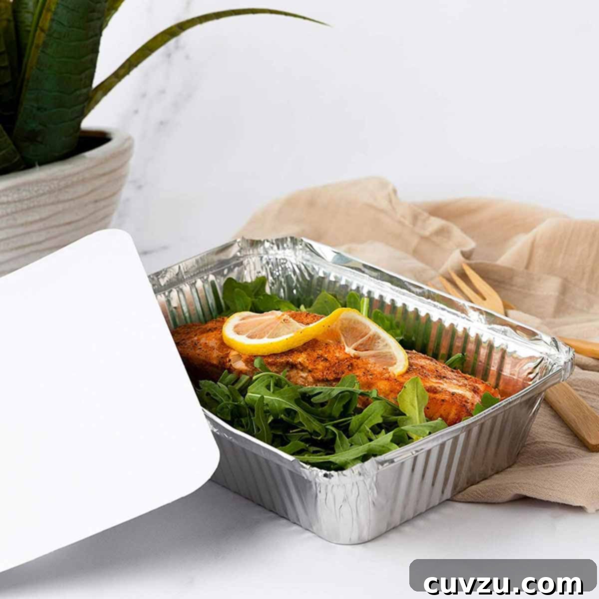 Smart Freezing: Your Guide to Food Preservation 3 A disposable aluminum pan filled with fresh salmon fillets, ready to be covered and frozen, showcasing a practical method for freezing prepared meals.