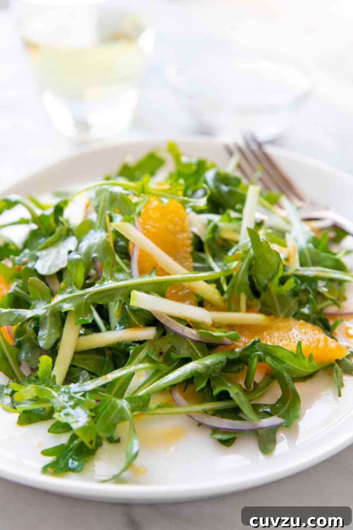 Shaved Fennel, Apple, and Orange Salad 6 A single plate of the vibrant Apple, Fennel, and Orange Salad, perfectly plated and ready to be enjoyed, showing off its beautiful textures and colors.