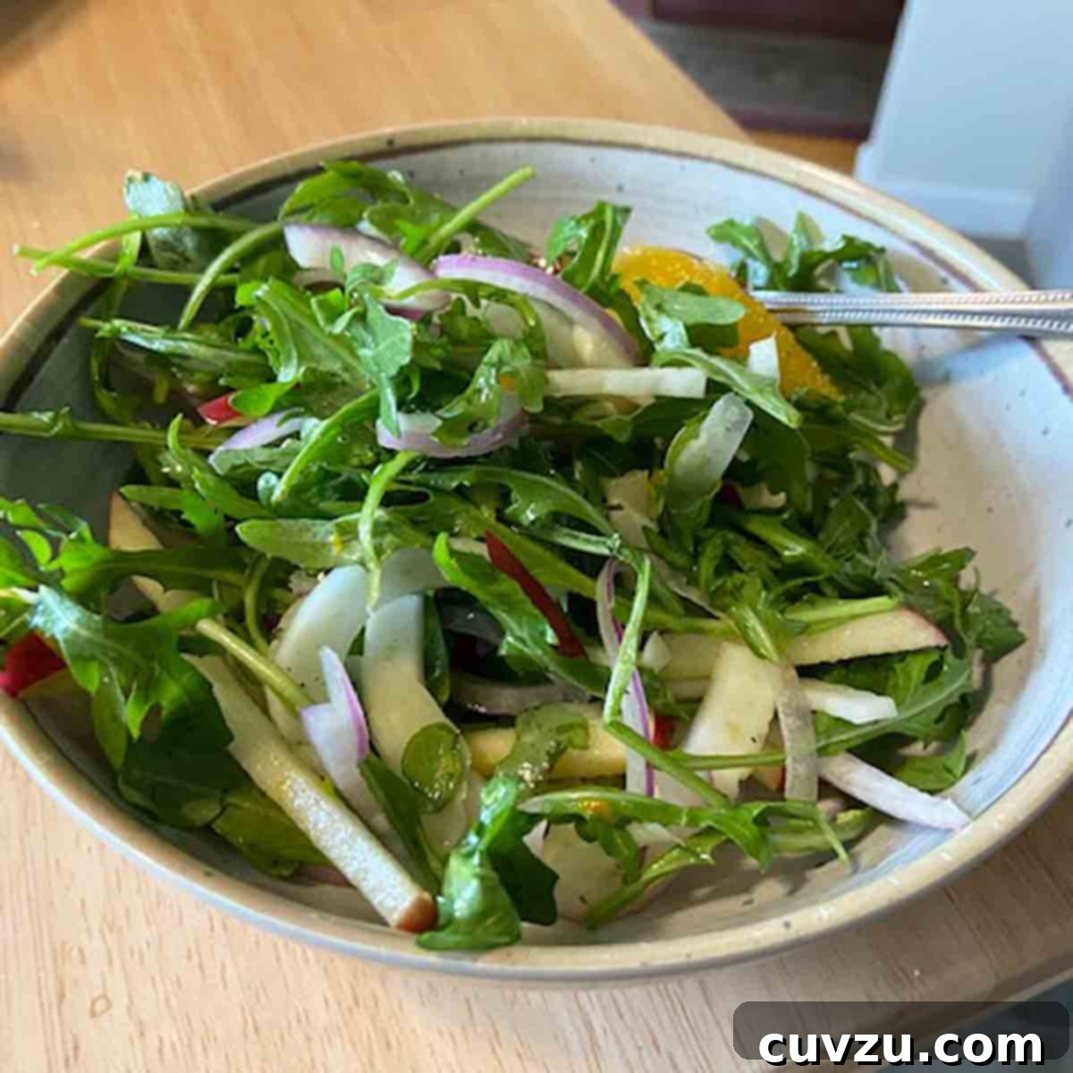 Shaved Fennel, Apple, and Orange Salad 7 A vibrant bowl of fennel and apple salad, beautifully garnished with fresh herbs, meticulously prepared by Lisa Amtower for testing.
