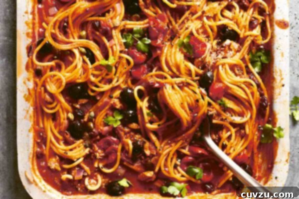 One-Pan Puttanesca Perfection 3 A tray of one-pan spaghetti puttanesca, featuring tender pasta, bright tomatoes, dark olives, and fresh parsley garnish.