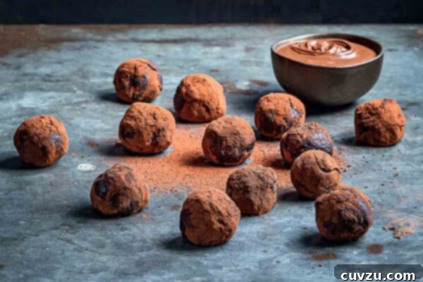 A visually appealing close-up of a dozen Nutella truffles on a blue tabletop, hinting at their rich, smooth texture and delicious flavor.