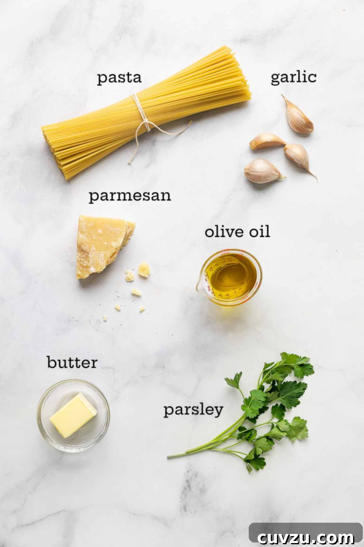 Velvety Butter Parmesan Pasta 4 Essential ingredients for garlic butter Parmesan pasta: spaghetti, fresh garlic cloves, a block of Parmesan cheese, a bottle of olive oil, fresh parsley, and a stick of butter.