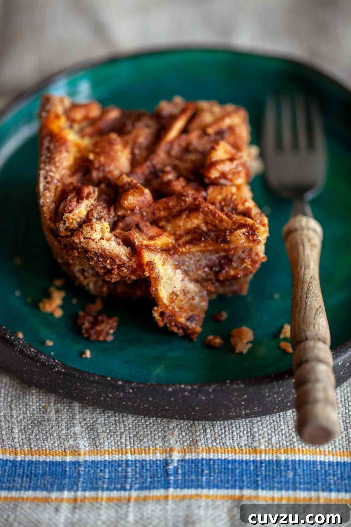 A delectable square of Passover apple cake resting elegantly on a vibrant green plate.