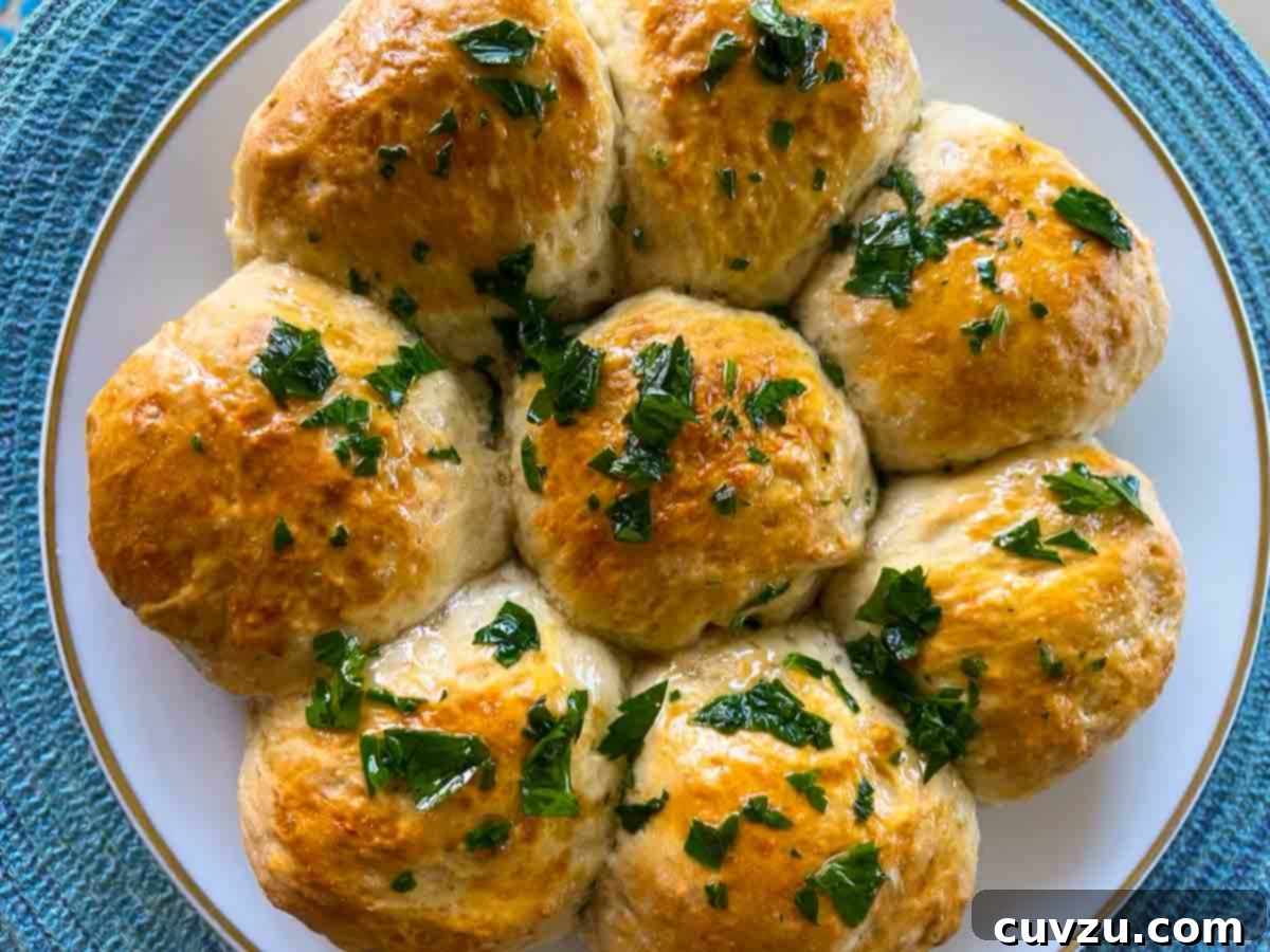 Pampushky Ukrainian Garlic Bread 8 Eight Ukrainian garlic bread rolls presented on a pristine white plate, radiating warmth and culinary appeal.