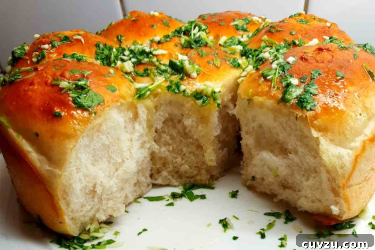 Pampushky Ukrainian Garlic Bread 6 Ukrainian garlic bread rolls generously covered with fresh garlic and parsley oil, showcasing their rich aroma and appealing texture.