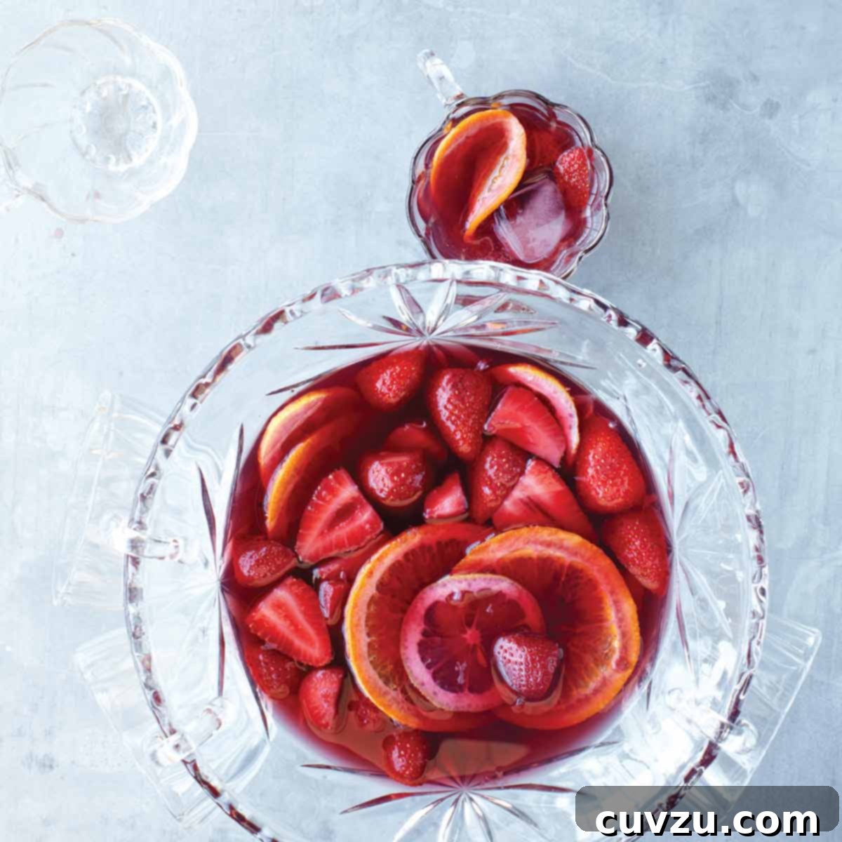 Sweet Summer: 5 Irresistible Strawberry Recipes 2 A punch bowl and several glasses filled with strawberry sangria, whole strawberries, and orange wheels.