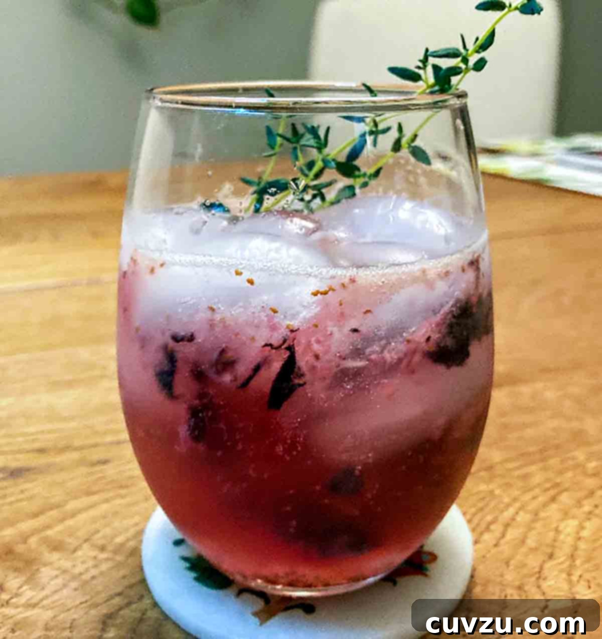 Blueberry Bliss Spritz 6 A glass of blueberry prosecco spritz with sprigs of thyme for garnish, prepared by Rema S.