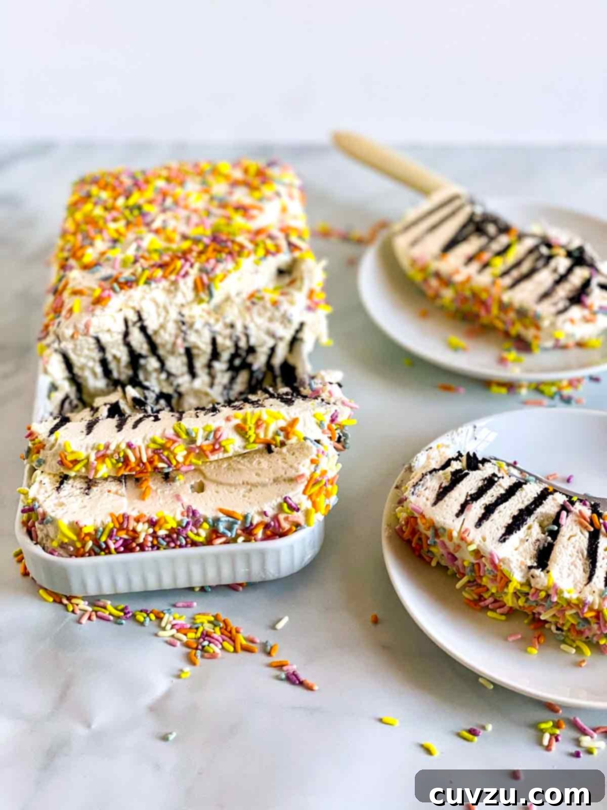 Chilled Sweet Cream Delight 3 A partially sliced icebox cake with condensed milk whipped cream and slices on two plates.