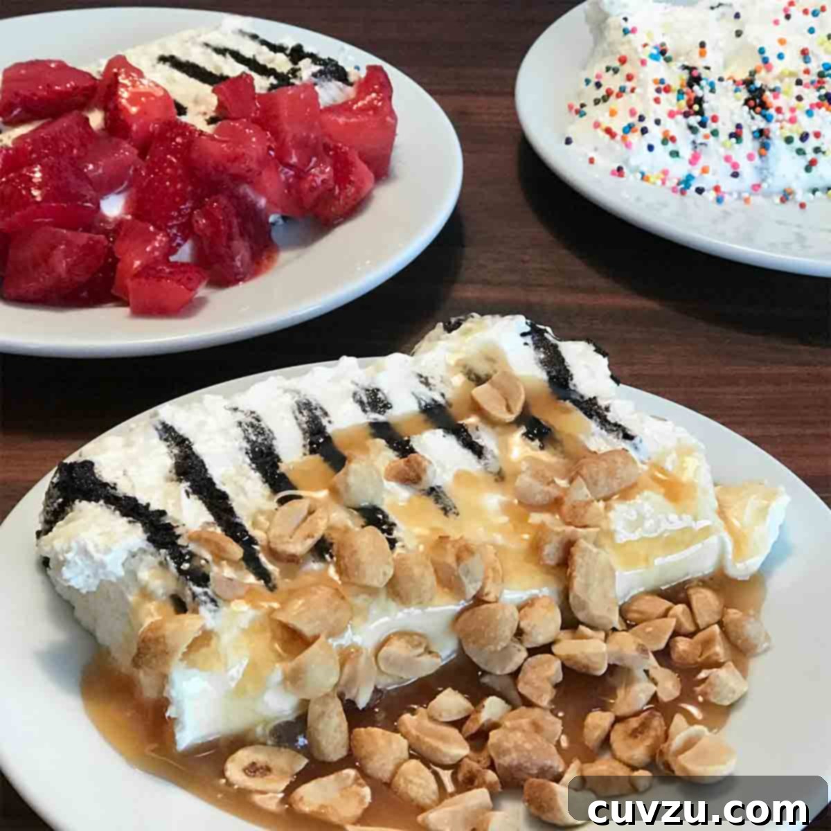 Chilled Sweet Cream Delight 7 A slice of icebox cake on white plate, topped with peanuts and caramels sauce and another slice topped with strawberries.