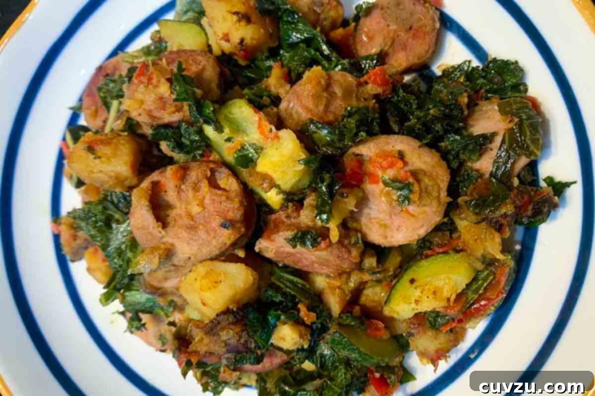 Hearty Sweet Potato Chicken Sausage Skillet 5 A blue and white plate filled with sweet potato and chicken sausage hash.