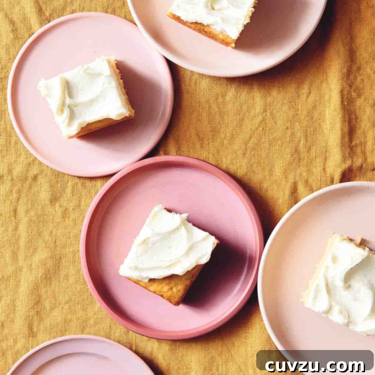 6 Irresistible Snacking Cakes You Need to Try 2 Individual servings of vanilla buttermilk cake with white frosting on pink plates. A simple yet elegant vanilla buttermilk cake, ready to be enjoyed.