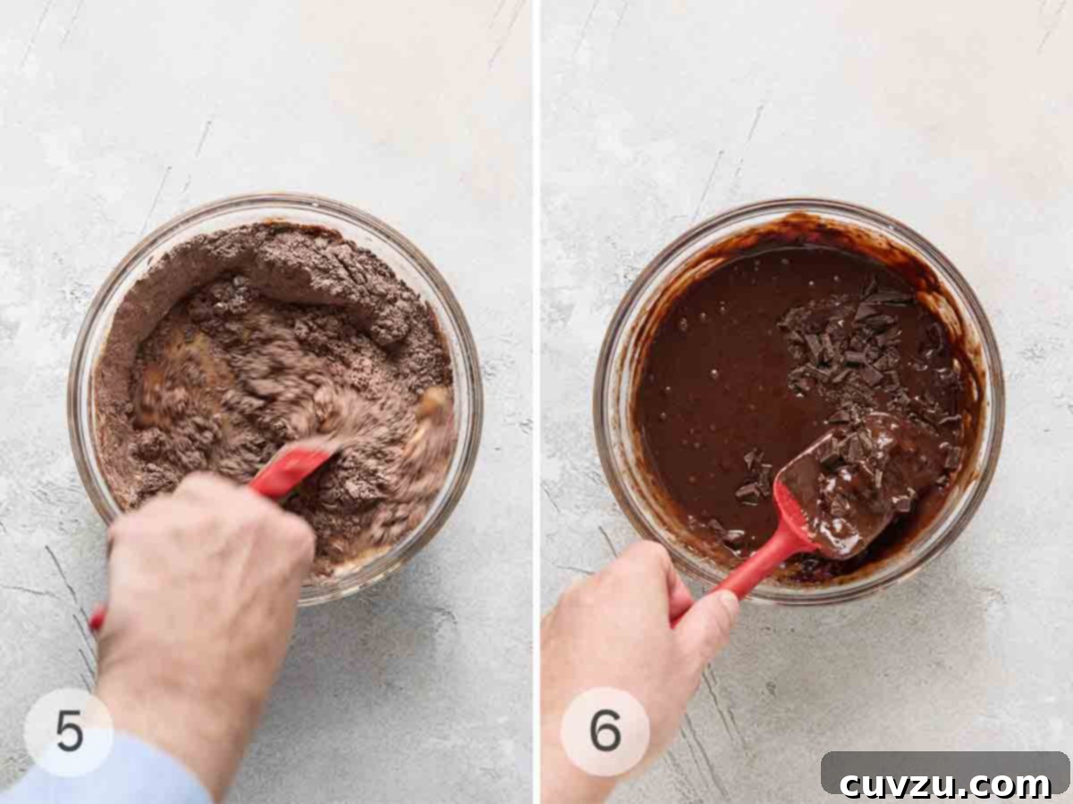 Irresistible Chocolate Muffins 7 A person mixing muffin batter in a glass bowl; chocolate pieces being folded into the muffin batter.