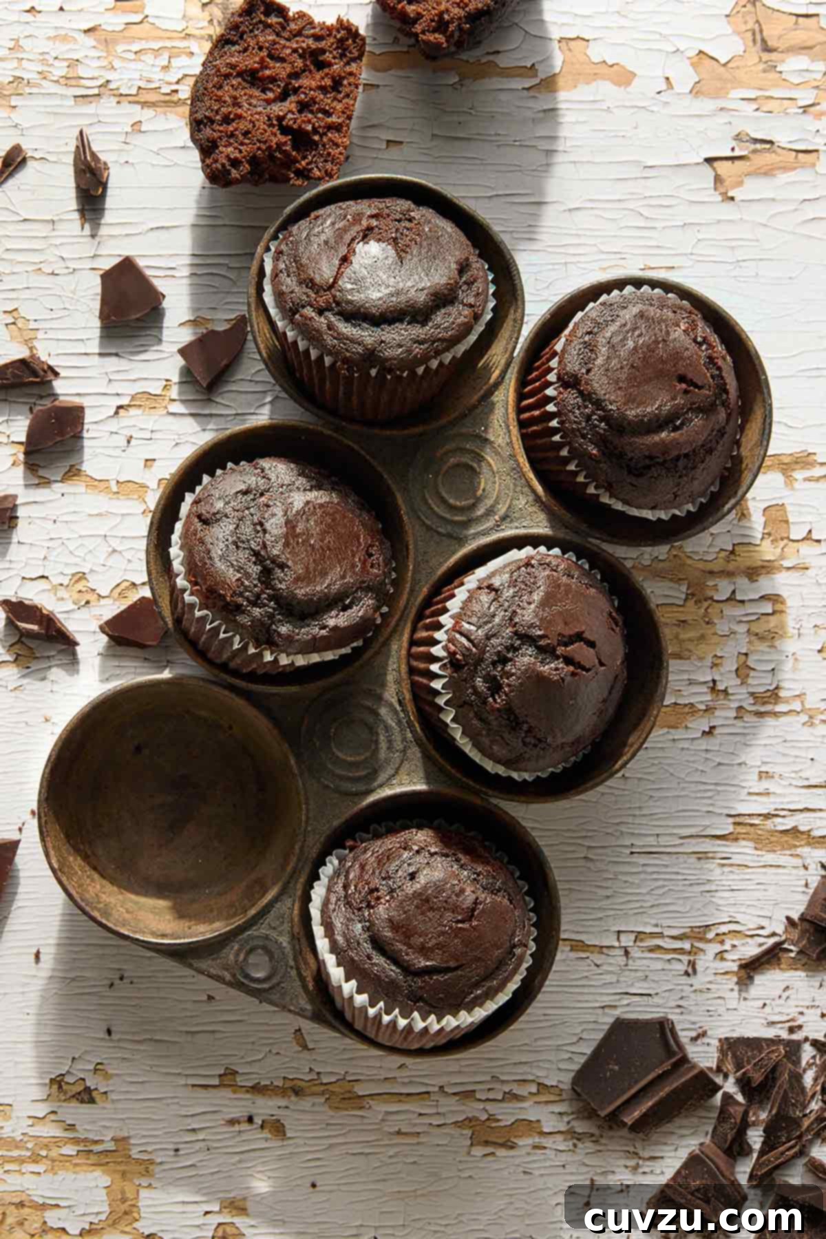 Irresistible Chocolate Muffins 9 Five chocolate muffins in an antique muffin tin.