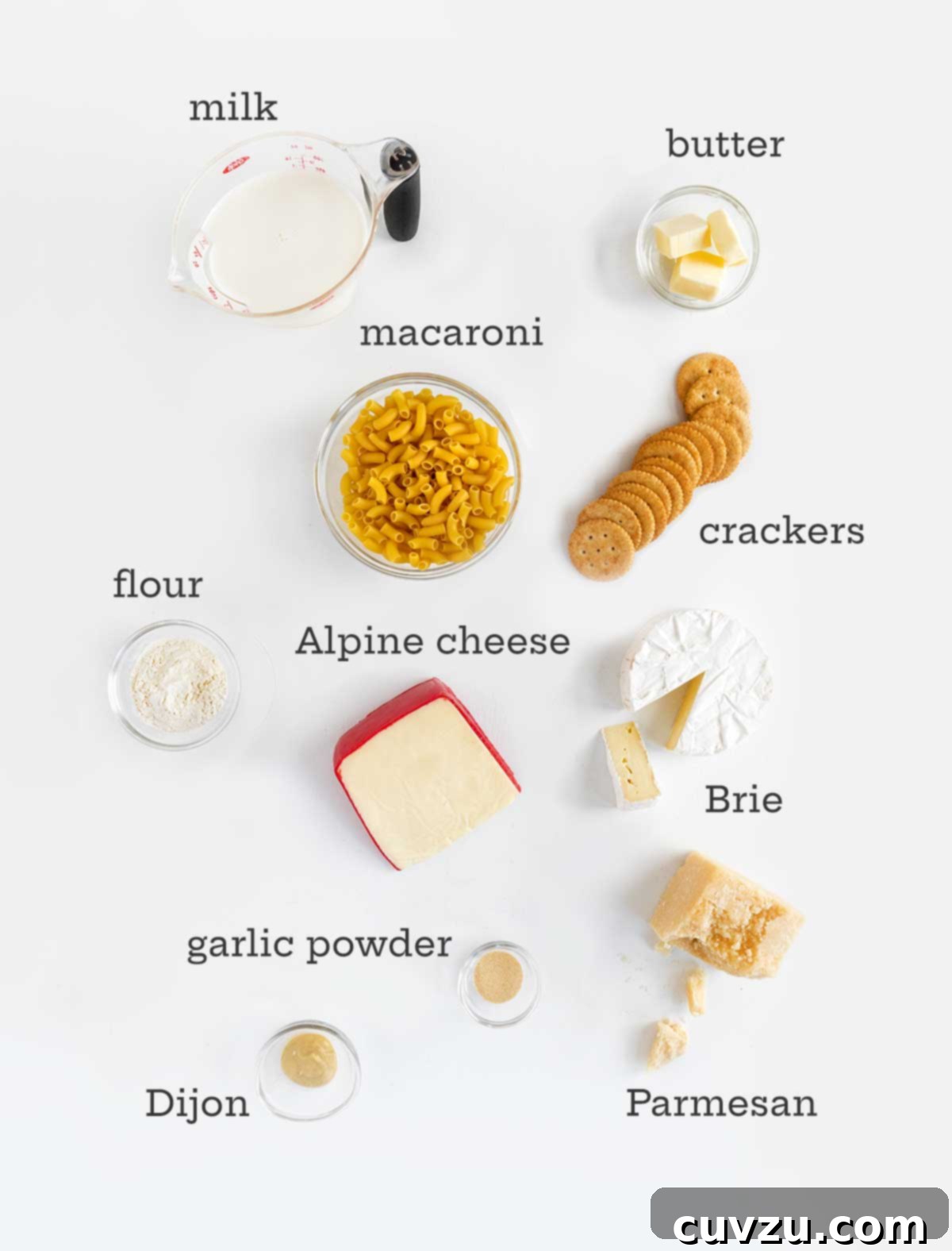 Decadent Brie Mac and Cheese 4 Ingredients for Brie mac and cheese -- Brie, pasta, crackers, butter, milk, flour, cheese, butter, garlic powder, and Dijon.