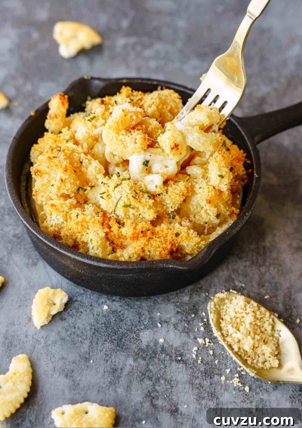 Decadent Brie Mac and Cheese 10 A small cast-iron skillet filled with Brie mac and cheese with a fork digging into it.