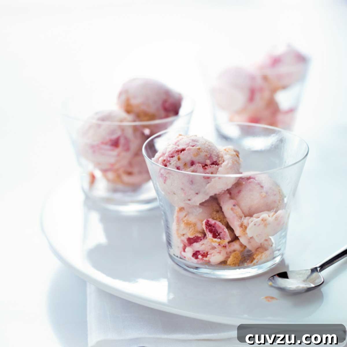 Sweet Six No-Churn Ice Cream Treats 5 Three glass bowls filled with scoops of strawberry cheesecake ice cream.