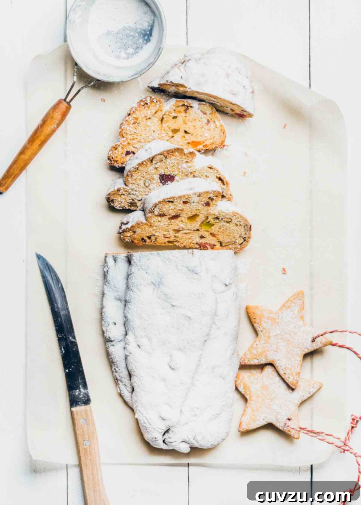 Festive Italian Sweet Bread 3 A slice of stollen, a traditional German Christmas bread, revealing its marzipan filling and studded with candied fruits.