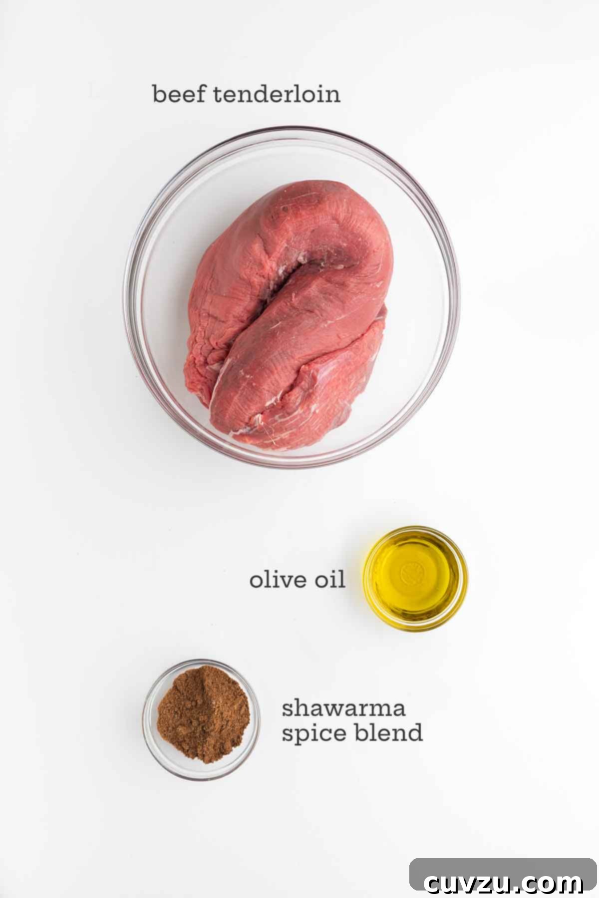 Aromatic Shawarma Beef Tenderloin Roast 4 Ingredients for spiced beef tenderloin roast: a whole beef tenderloin, a bottle of olive oil, and a bowl of homemade shawarma spice blend.
