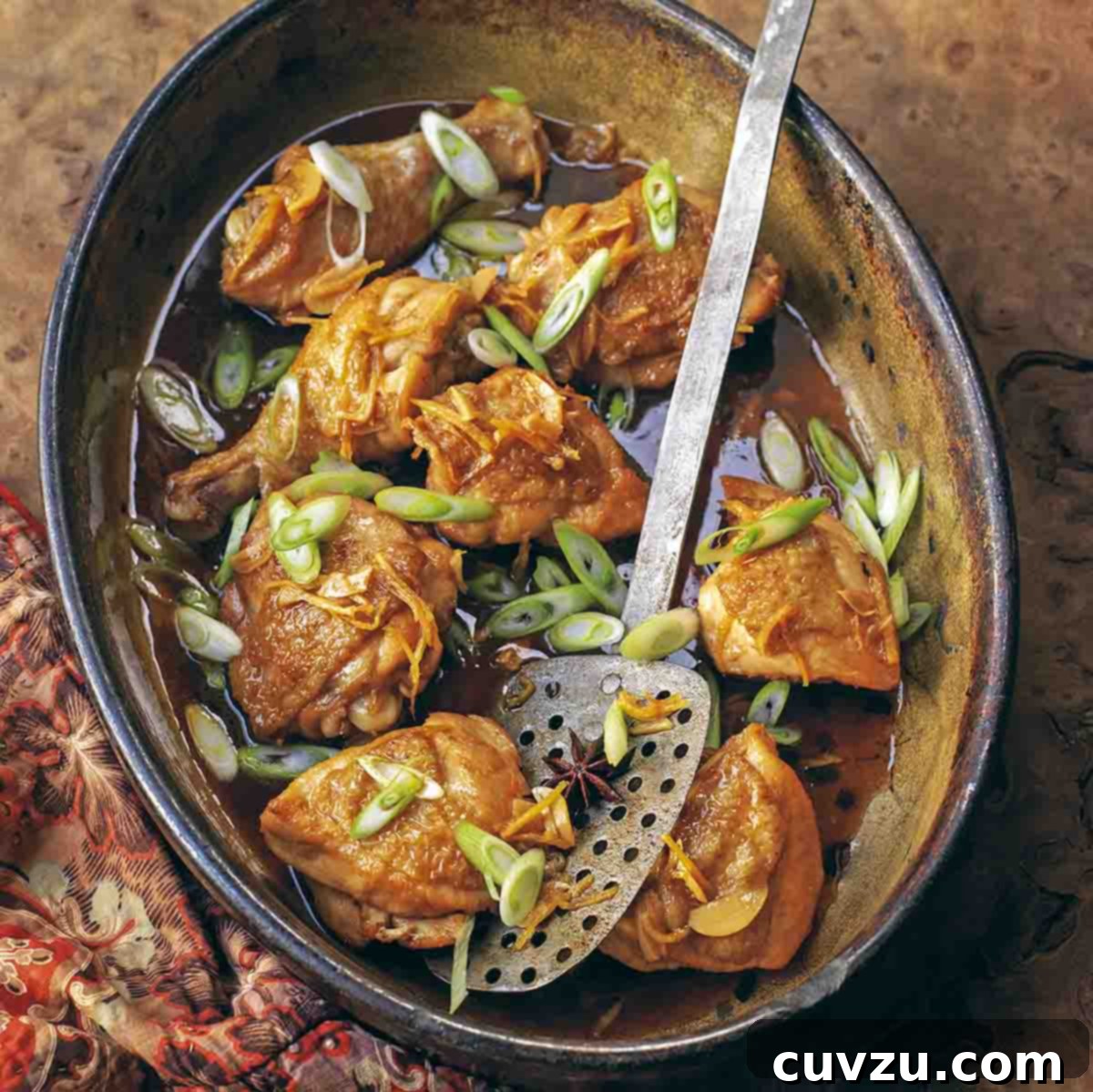 Six Flavorful Bone-In Chicken Breast Dinners 4 A crock filled with browned chicken thighs and sliced scallions, a spatula in the middle.