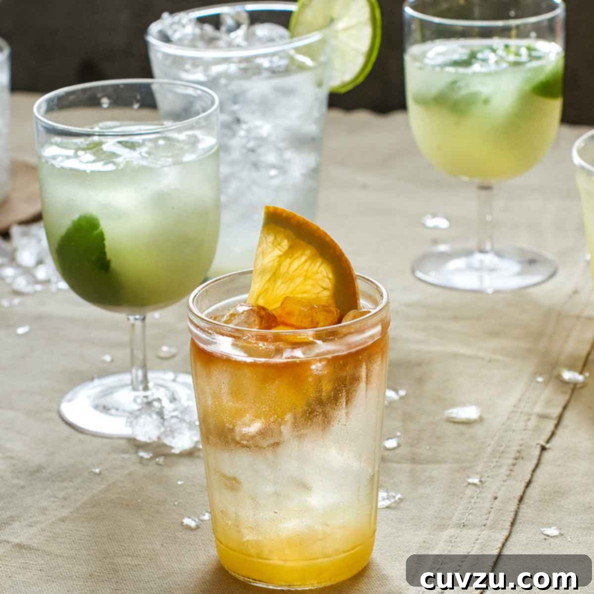 Two glasses of lime soda and one glass of angostura orange.