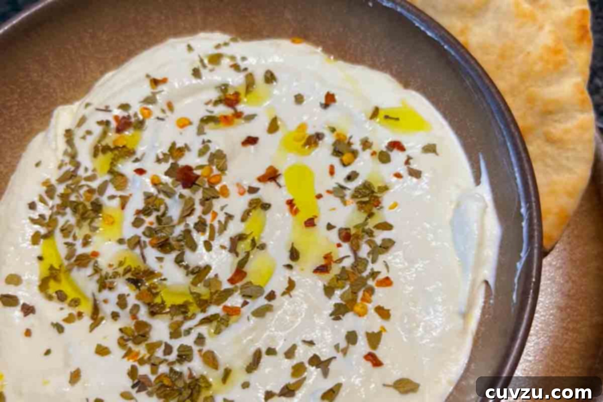 Creamy Whipped Feta 19 A bowl of creamy whipped feta dip topped with oil and dried herbs.