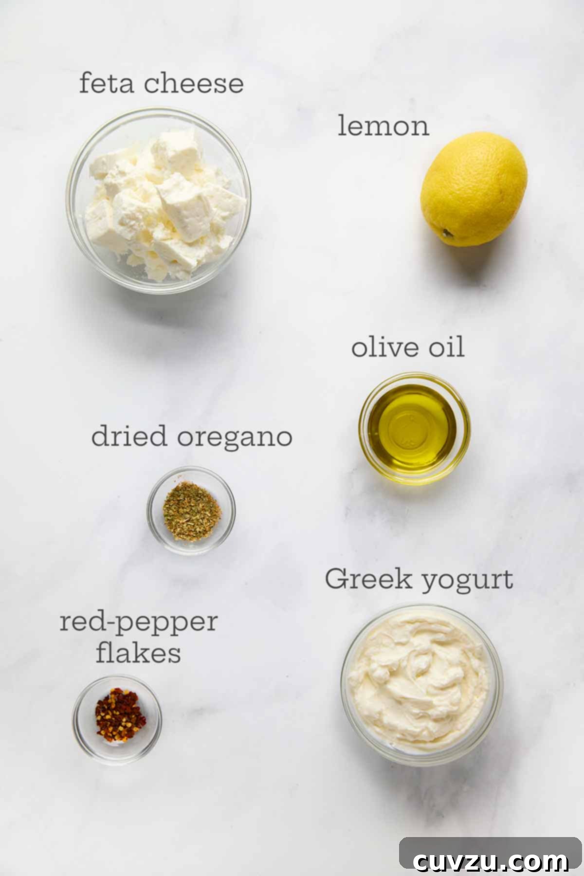 Creamy Whipped Feta 5 Ingredients for whipped feta dip--feta cheese, lemon, olive oil, oregano, yogurt, and pepper flakes.