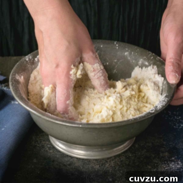 Shortcut pie crust being mixed together by hand in a bowl, highlighting the ease of preparation.