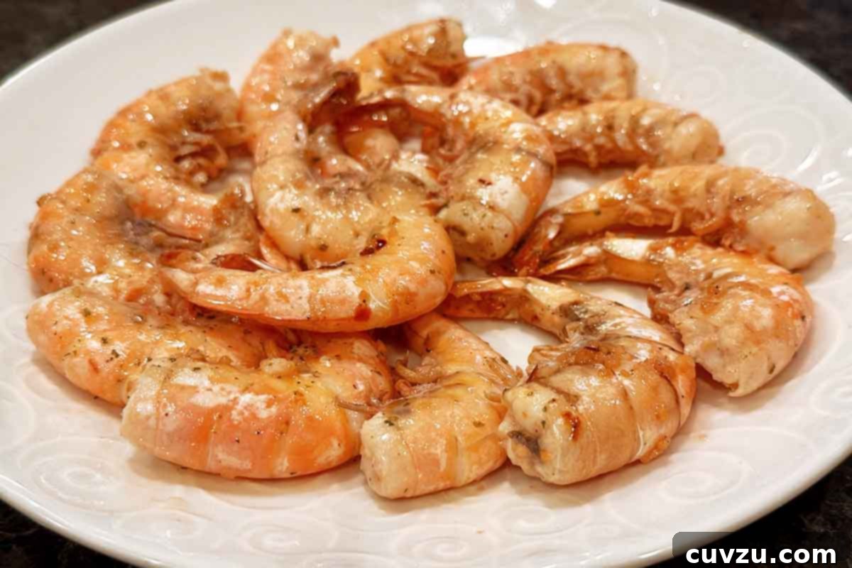 Garlic Lemon Shrimp Scampi 13 A plate of classic shrimp scampi--large shrimps in their shells on a garlic butter sauce.