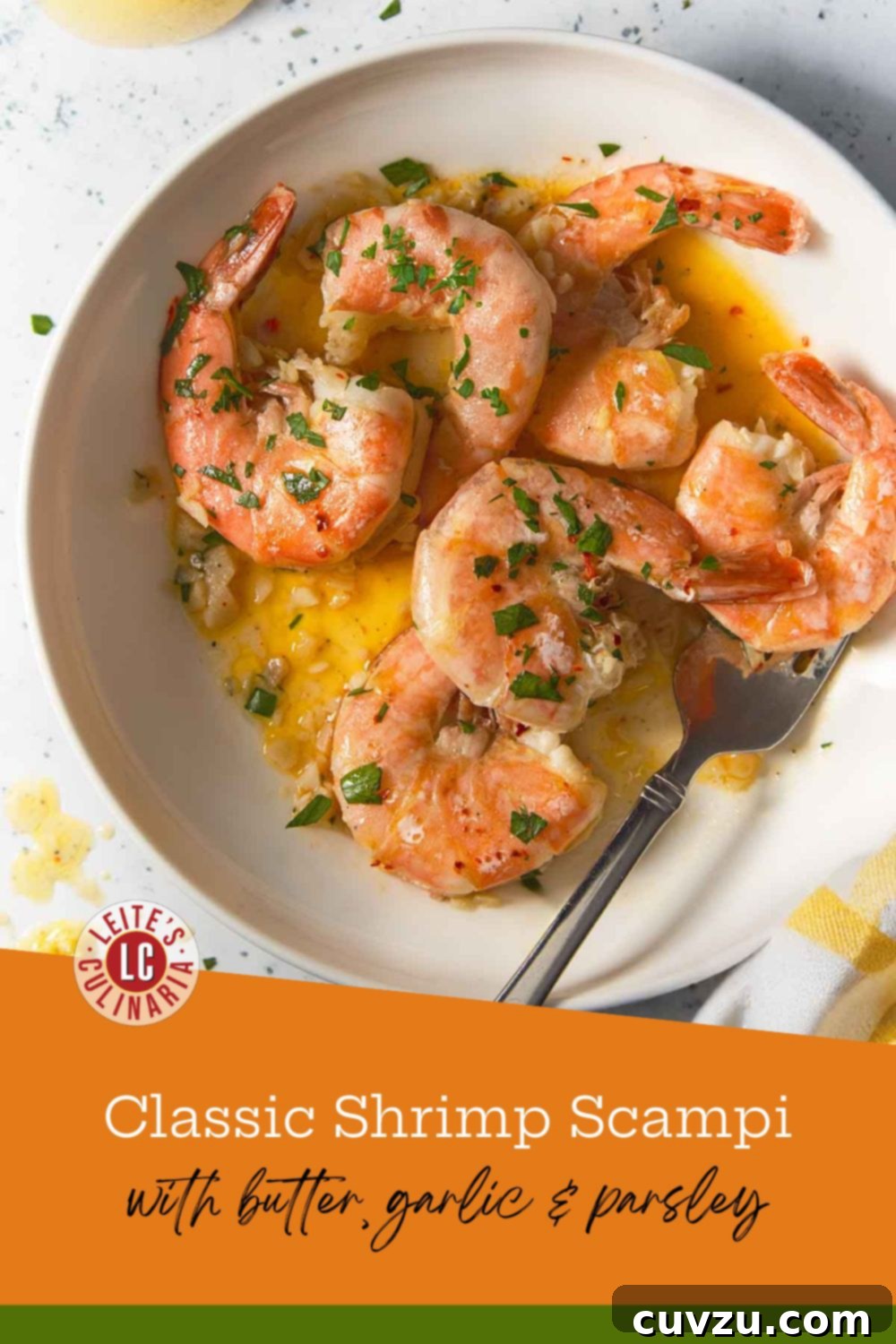 Garlic Lemon Shrimp Scampi 3 Shrimp scampi in a white bowl topped with parsley, sitting in a garlic butter sauce with visible lemon zest and a fork.