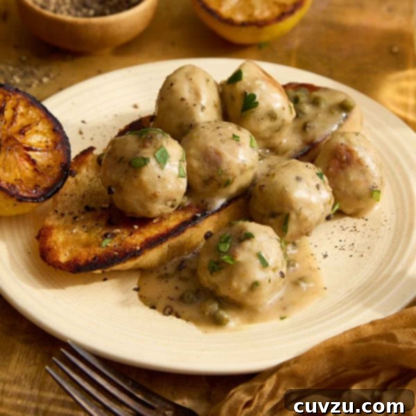 Lemon Caper Chicken Meatballs 15 Square image of chicken meatballs with piccata sauce on grilled bread and a cream plate.