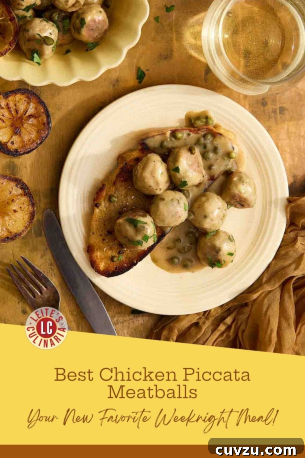 Plate of chicken piccata meatballs in golden sauce on sourdough, with charred lemons nearby.